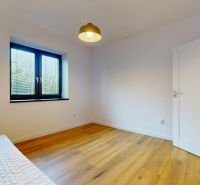 A bright room in a family house with a window and a wooden decor floor.