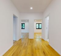 Interior of a family house with a wooden decor floor and white walls.