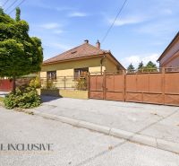 A family house in Dunajská Streda with a brown gate and a landscaped front garden.