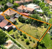 A family house in Dunajská Streda with a large plot of land and sparse vegetation.