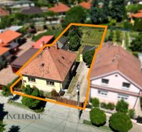 A family house in Dunajská Streda with a garden, surrounded by neighboring houses and greenery.