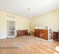 A living room in a family house with wooden decor and classic style furniture.