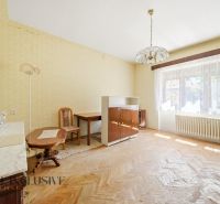 A room in a family house with a wooden decor floor, furnished in retro style.