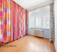Colorful curtains and a wooden decor floor in a 3-room apartment.