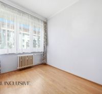 A room in a 3-room apartment with a wooden decor floor and a large window.