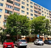 6-storey apartment building with trees and parked cars on Pri kríži in Bratislava.
