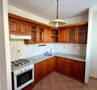 A kitchen with a corner kitchen unit, wooden cabinets, and a gas stove in a 4-room apartment.