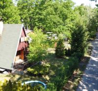 A cottage in Šaštín-Stráže on Do Gazárky street surrounded by greenery and a forest path.
