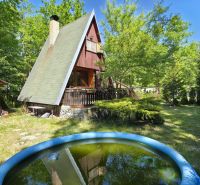 Cottage at Gazárka in Šaštín-Stráže with a pool, surrounded by greenery and a wooden shelter.