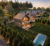 Gardens with modern houses and a swimming pool in the Hlinícka area, Myjava, at sunset.