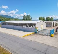 Production premises in Považská Bystrica with extensive outdoor parking and surrounding greenery.