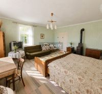 Interior of a family house with furniture, a tiled stove, and a bed, a room in pleasant colors.
