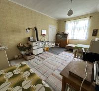 A traditional kitchen with a stove and wooden cabinets in a family house.
