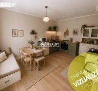 Interior of a family house with a kitchen, dining table, and wooden decor flooring.