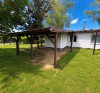 A cottage in Kopčany with a covered shelter and a grassy area in the garden.