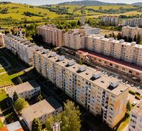 View of the housing estate on 9th May Street in Brezno with surrounding greenery.