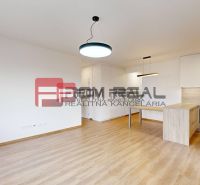 Living room with a kitchen and wooden decor flooring in a 3-room apartment.