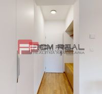 A hallway in a 3-room apartment with a wooden decor floor and storage space.