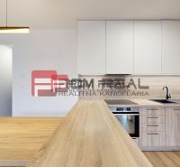 A kitchen in a 3-room apartment with a wooden decor floor and modern lighting.