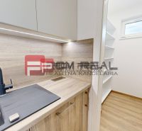 A kitchen in a 3-room apartment with a sink and a built-in wardrobe. Floor with wood decor.