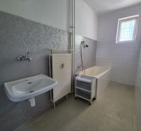 Bathroom in a 3-room apartment with a shower bath, sink, and window.