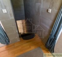 The interior of a cabin with stairs and a wooden decor floor, complemented by curtains.