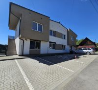 Apartment building in Štiavnik, Štiavnik with a parking lot and sunny sky suitable for a 1-bedroom apartment.