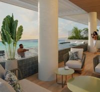 Terrace with loungers, a pool, a sea view, and a wooden decor floor in Paje.