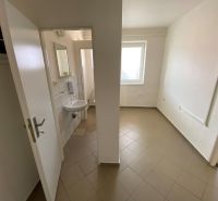 Commercial space with a sink, tiled floor, and white walls.
