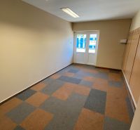 Commercial space with hangers and geometric pattern on the wooden decor floor.