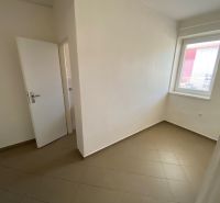 Room in commercial premises with white walls and tiles, neutral design.