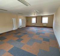 Spacious commercial spaces with windows and geometric flooring.