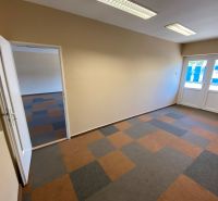 Interior of commercial spaces with multicolored flooring and glass doors.