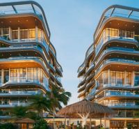 Design apartment buildings with glass facades in Paje surrounded by tropical vegetation.