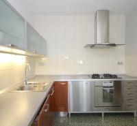 A kitchen in a 3-room apartment with stainless steel equipment and a laminate countertop.