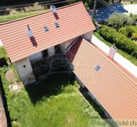 A family house in Klátova Nová Ves with a red roof and a green garden.