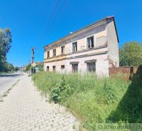 An abandoned family house in Klátova Nová Ves with damaged facade and overgrown land.