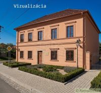 A family house in Klátova Nová Ves with windows, benches, and pavement on the street.