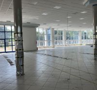 Bright commercial spaces with glass walls and tiling, ideal for various uses.