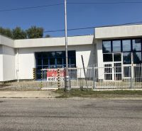 Commercial premises on 1. mája Street in Hurbanovo with a white facade and blue windows.