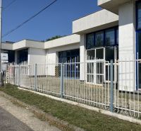 Commercial premises on 1st May Street, Hurbanovo, with large glass windows and a fence.