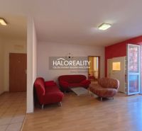 Living room in a 3-room apartment with a wooden decor floor and red sofas.