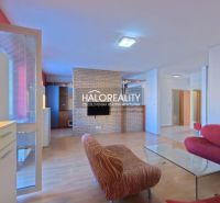 Living room in a 3-room apartment with brick cladding and a wooden decor floor.