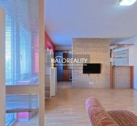In the 3-room apartment, the floor with a wooden decor, the brick wall, and the bright interior dominate.
