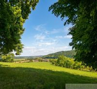 A view of the landscape around Ozdín with meadows and hills.