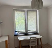 White desk, chair, and wooden decor flooring in a 3-room apartment.