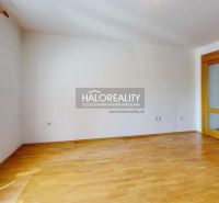 A spacious room with entrance doors and a wooden decor floor in a 3-room apartment.