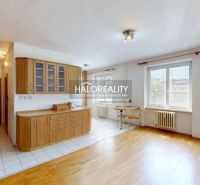 Kitchen corner with wooden kitchen cabinets in a 3-room apartment, floor with wooden decor.