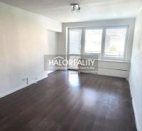 Living room in a 3-room apartment with wood-patterned flooring and large windows.