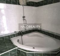 Corner bathtub with tiling in the bathroom of a 3-room apartment.
